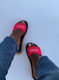 a woman's feet in a pair of flip flops with the word'spread'on them