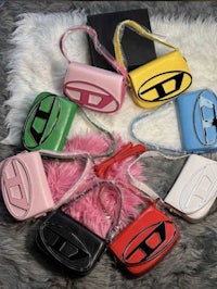 a group of colorful handbags with a logo on them