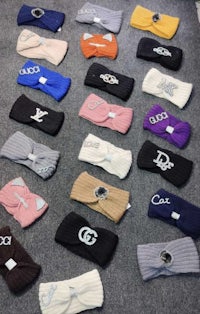 a variety of knitted headbands are laid out on the floor